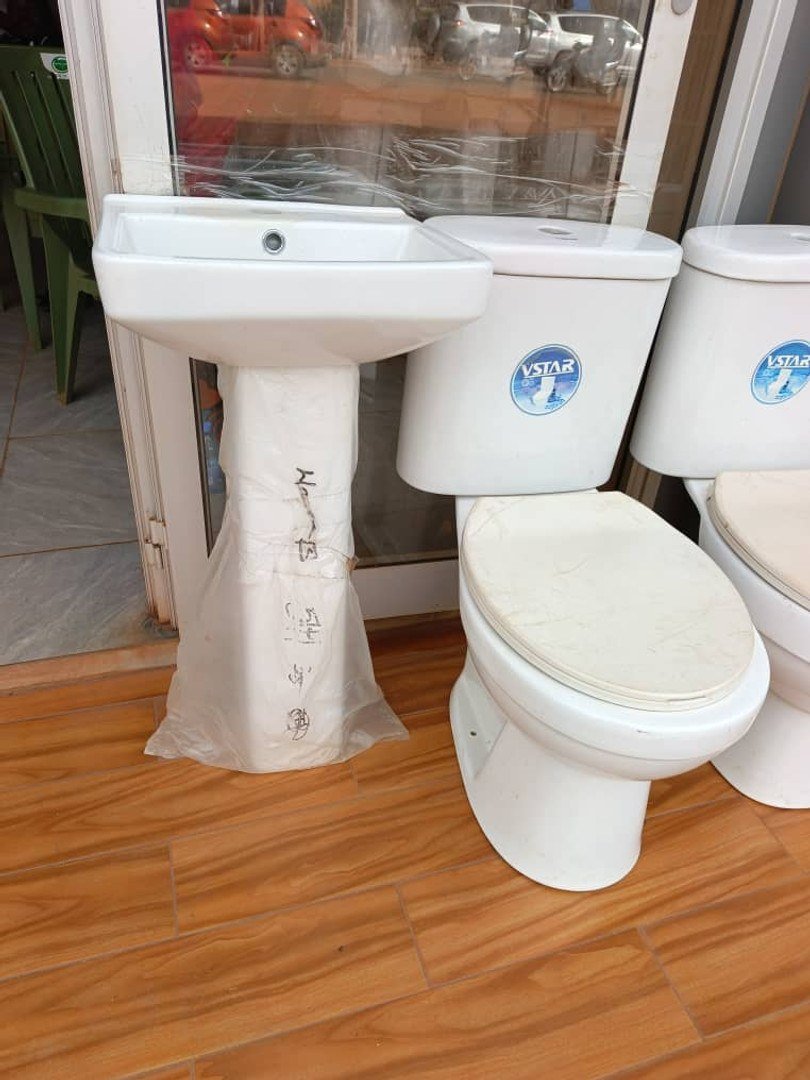 Lavabo sur pied et WC blanc photographiés devant la boutique